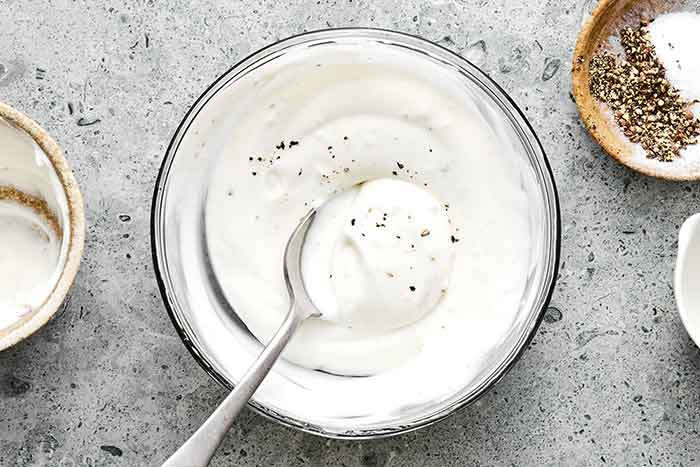 Making creamy dressing for cucumber salad.
