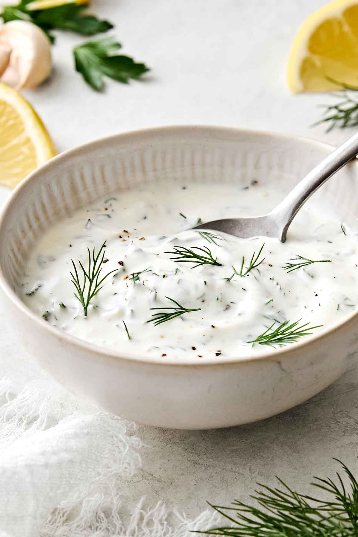 A bowl of lemon dill yogurt sauce.