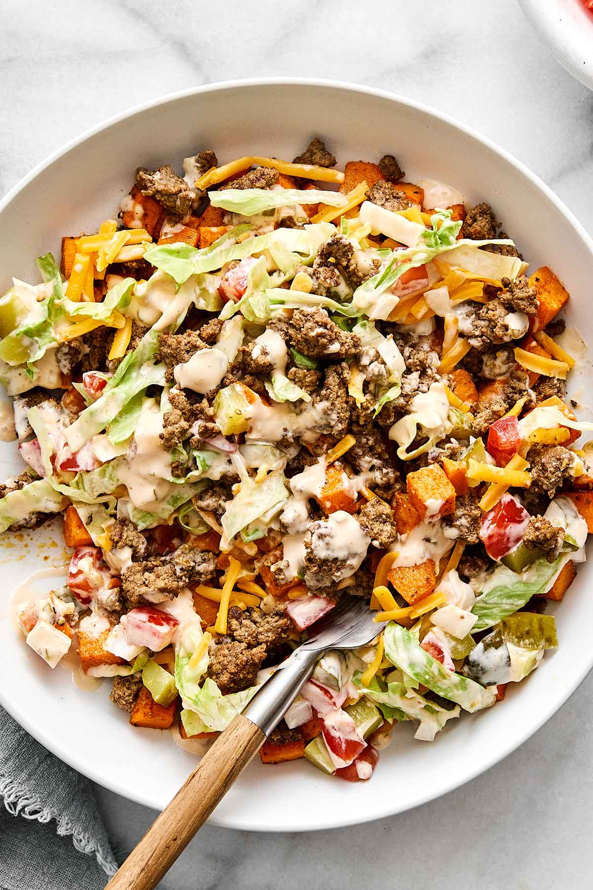 This sweet potato burger bowl is the best kind of weeknight dinner. It's all the tasty layers of an In-N-Out burger, but leans healthier! Sweet potato burger bowl.