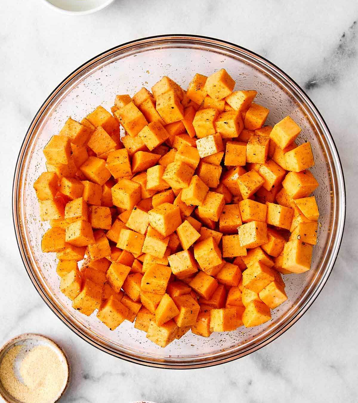 This sweet potato burger bowl is the best kind of weeknight dinner. It's all the tasty layers of an In-N-Out burger, but leans healthier! Tossing sweet potatoes in seasoning.