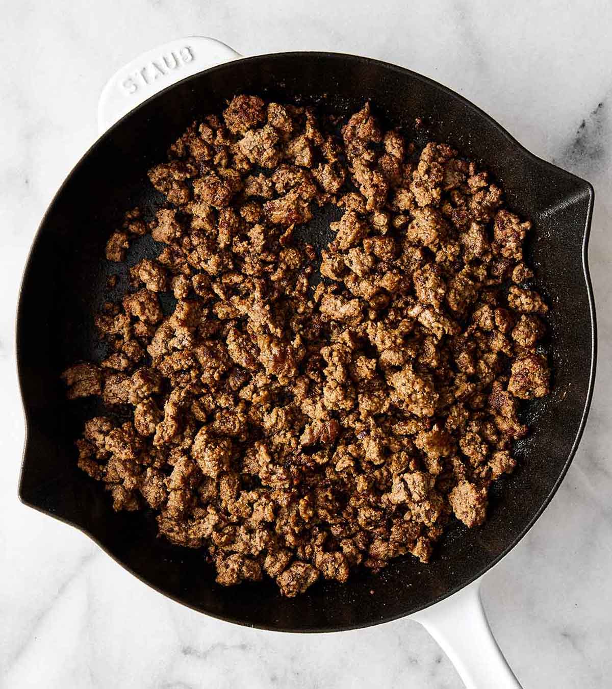 This sweet potato burger bowl is the best kind of weeknight dinner. It's all the tasty layers of an In-N-Out burger, but leans healthier! Cooking ground beef in a pan.