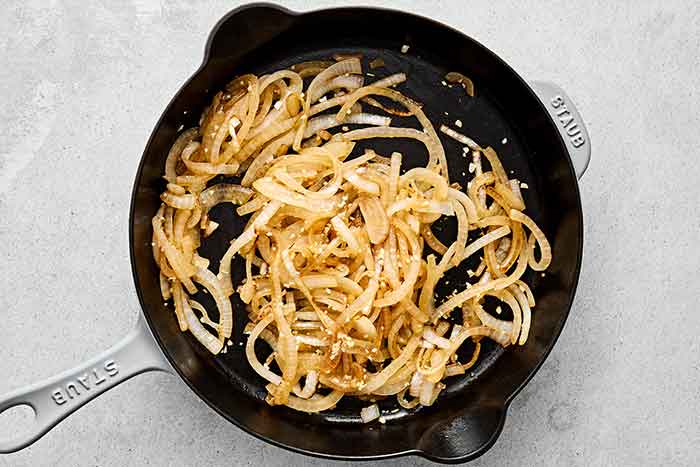 Sauteed onions in a pan for chicken tinga.