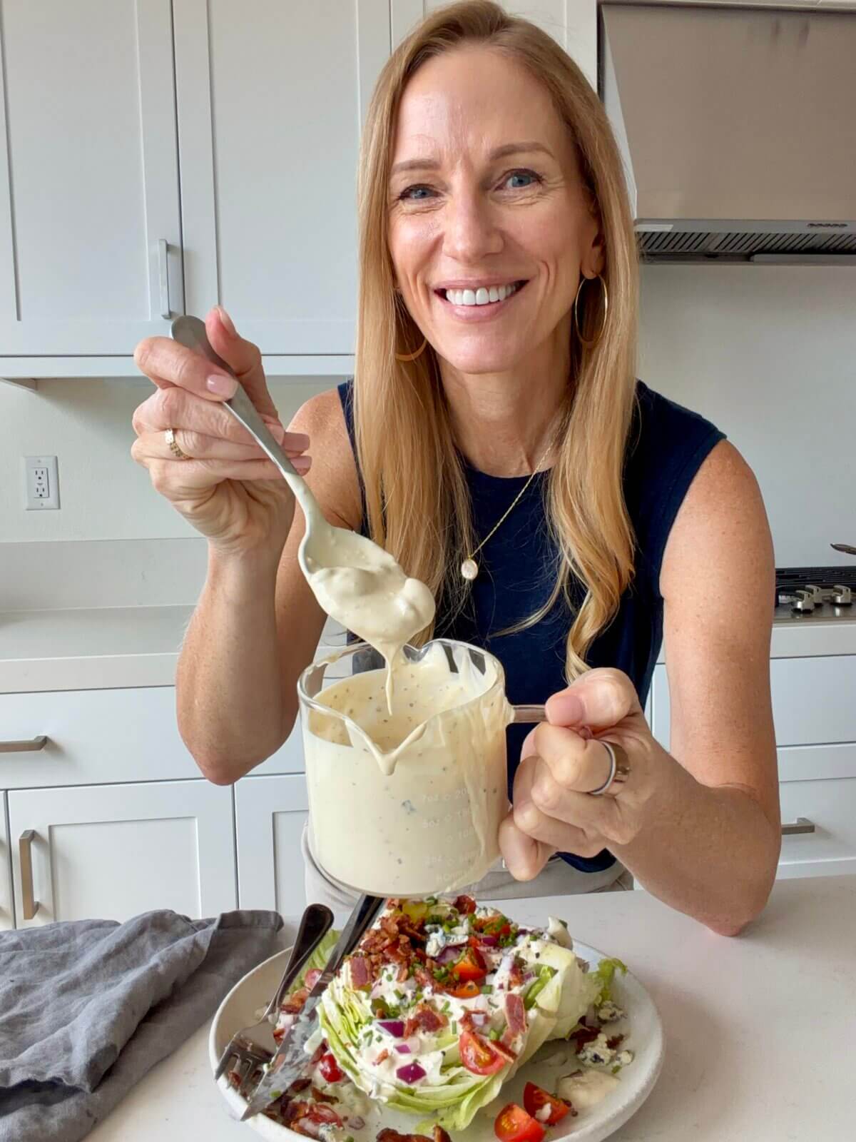 Lisa holding a bowl of blue cheese dressing.