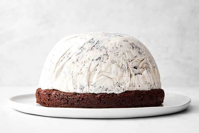 Freezing ice cream on top of chocolate cake for a baked Alaska.