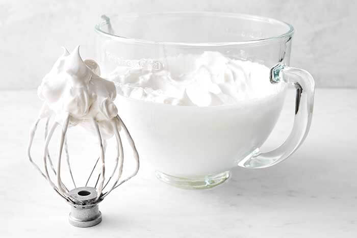 Making the meringue topping for a baked Alaska.