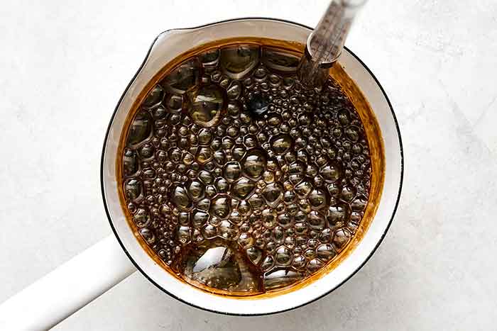 Caramelizing coconut sugar in a pot.