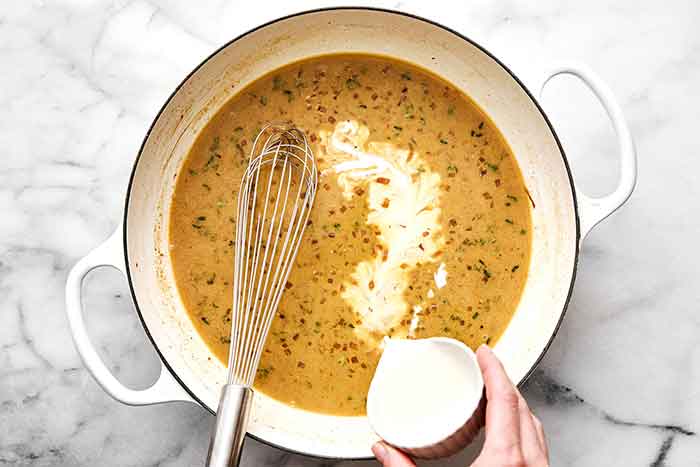 Making chicken Dijon sauce in a pan.