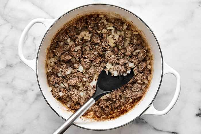 Cooking ground beef in a pot.